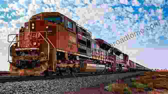 A Train Hauling Iron Ore On The Malmbanan Railroad, With The Snow Capped Mountains Of The Arctic Circle In The Background Running With IOREs 2024 Heavy Railroading On The Nordic Malmbana